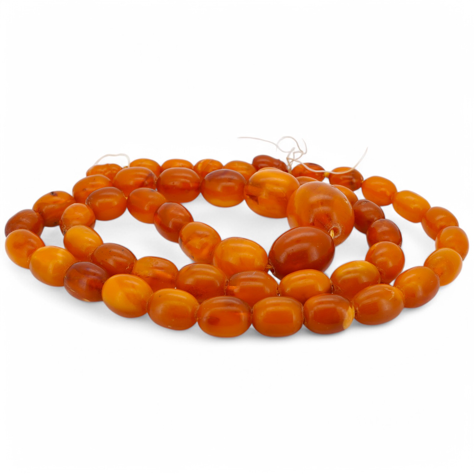 A single strand graduated oval amber bead necklace, 66cm, gross weight 63 grams. Condition - poor to fair